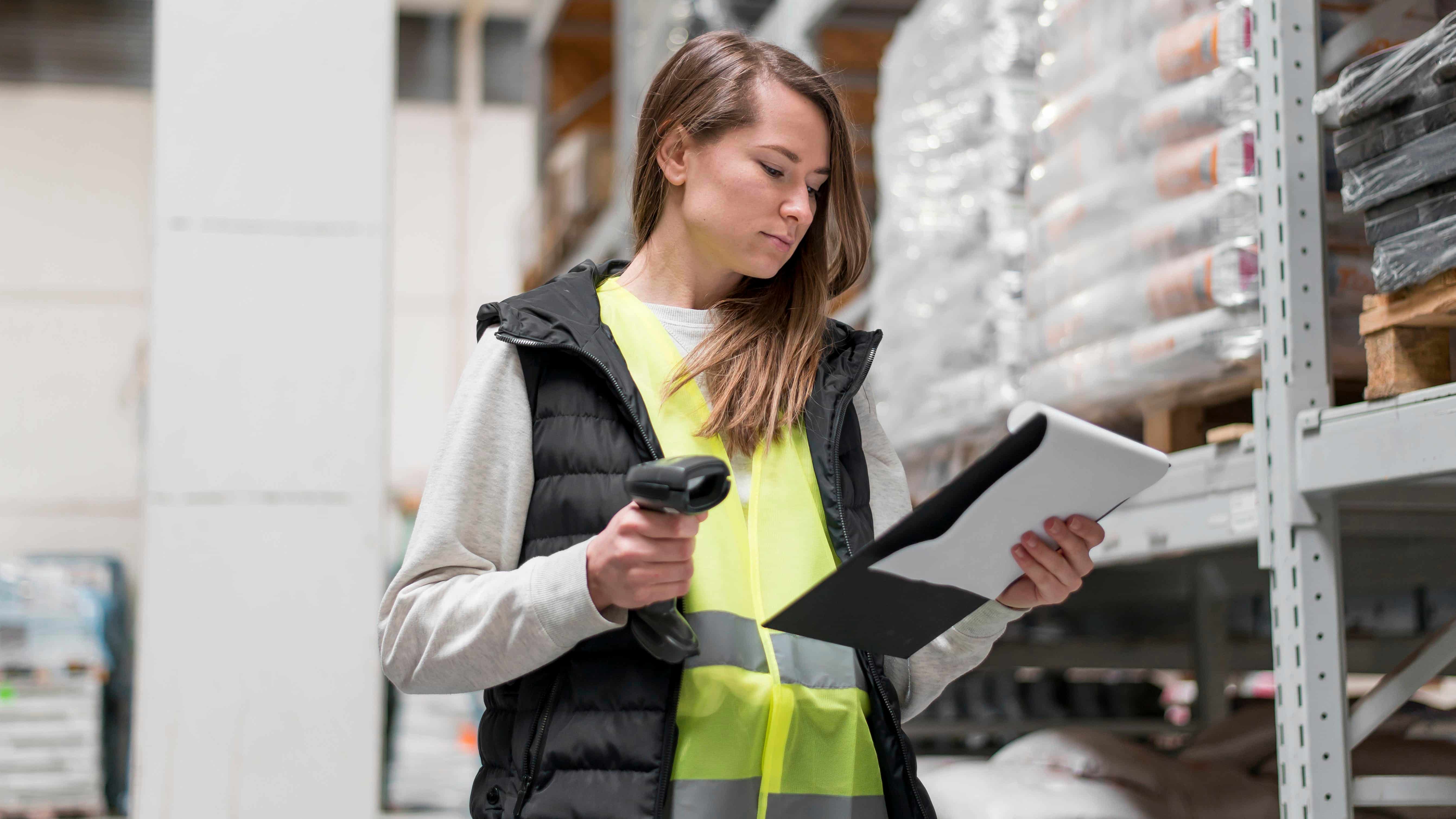 Warehouse worker with scanner checking inventory